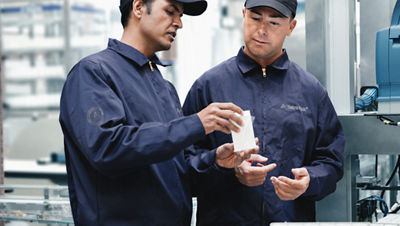 two tetra pak engineers discussing a machine part